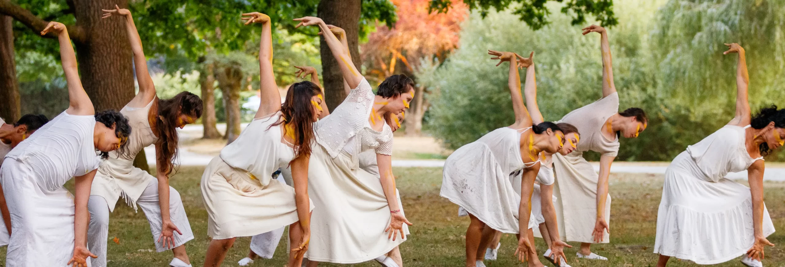 two dancers reaching arms towards each other on a stage