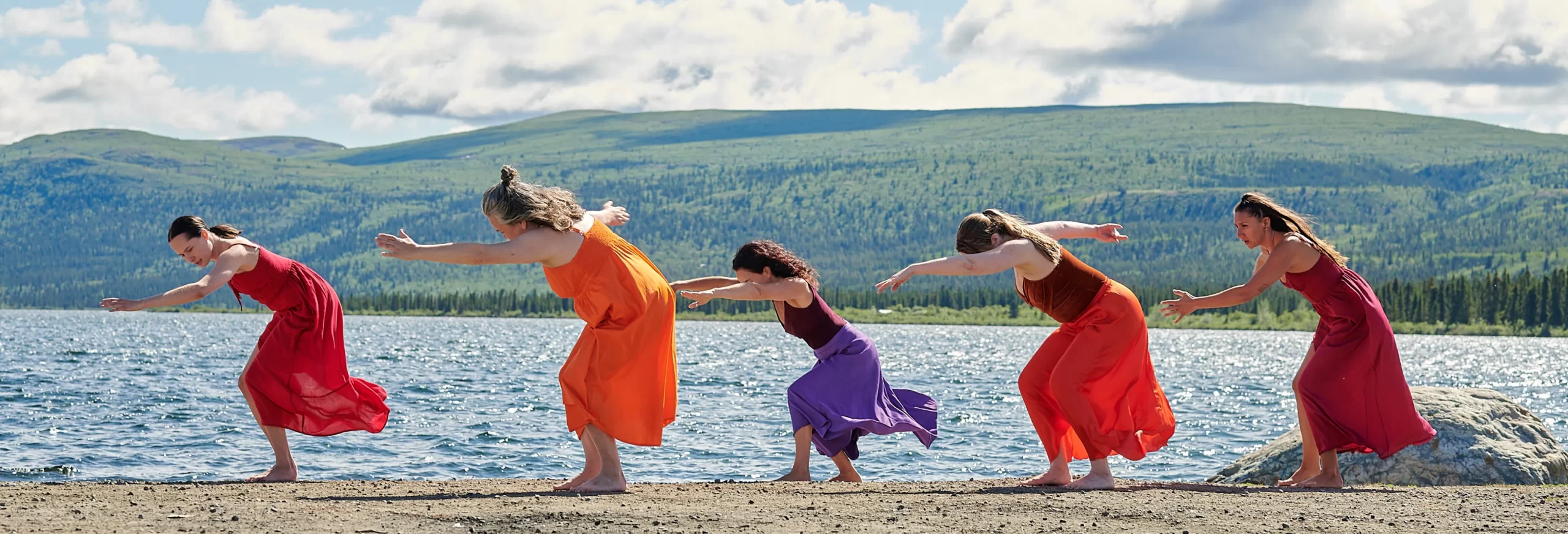 two dancers reaching arms towards each other on a stage
