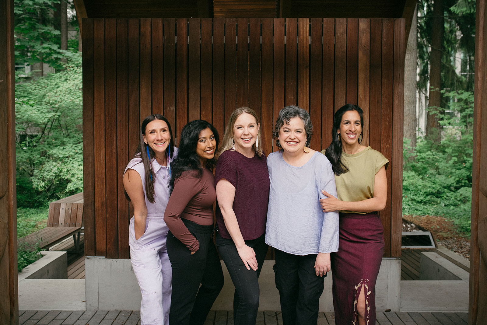 Five people standing in front of mountains