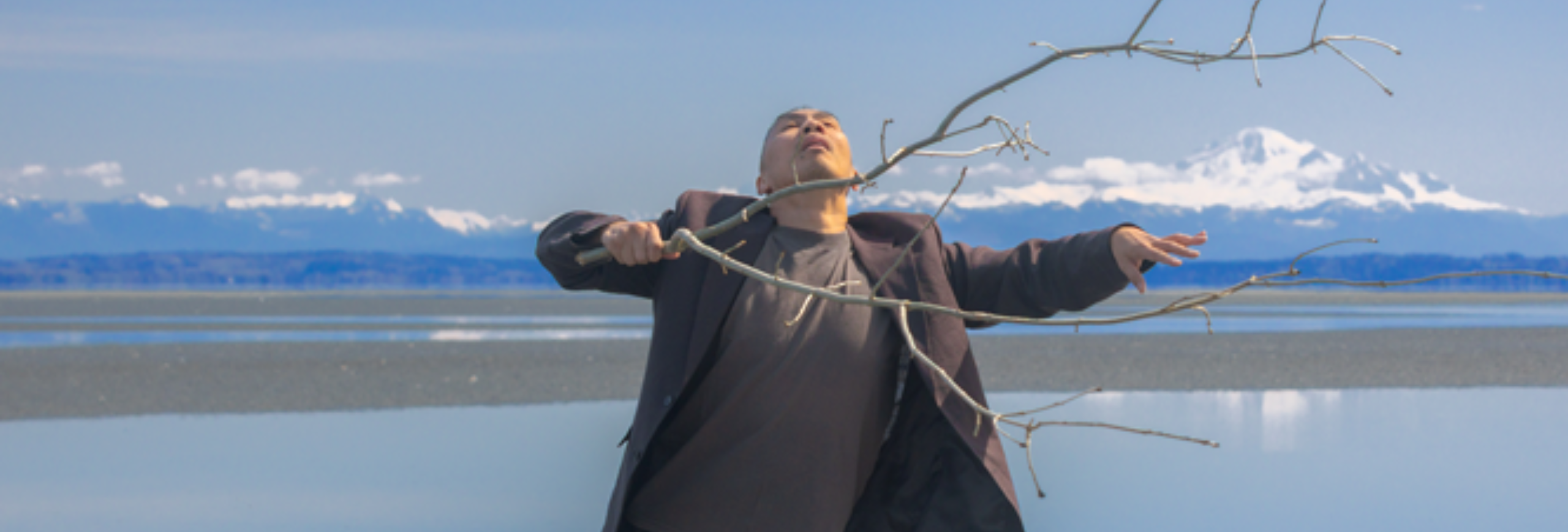 two dancers reaching arms towards each other on a stage